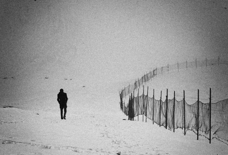Man walking alone in snow near border. Credit: Seyed Mostafa Zamani on Flickr