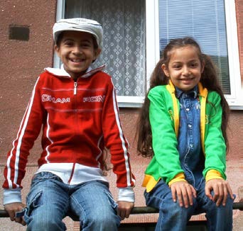 Happy children sitting on a wall